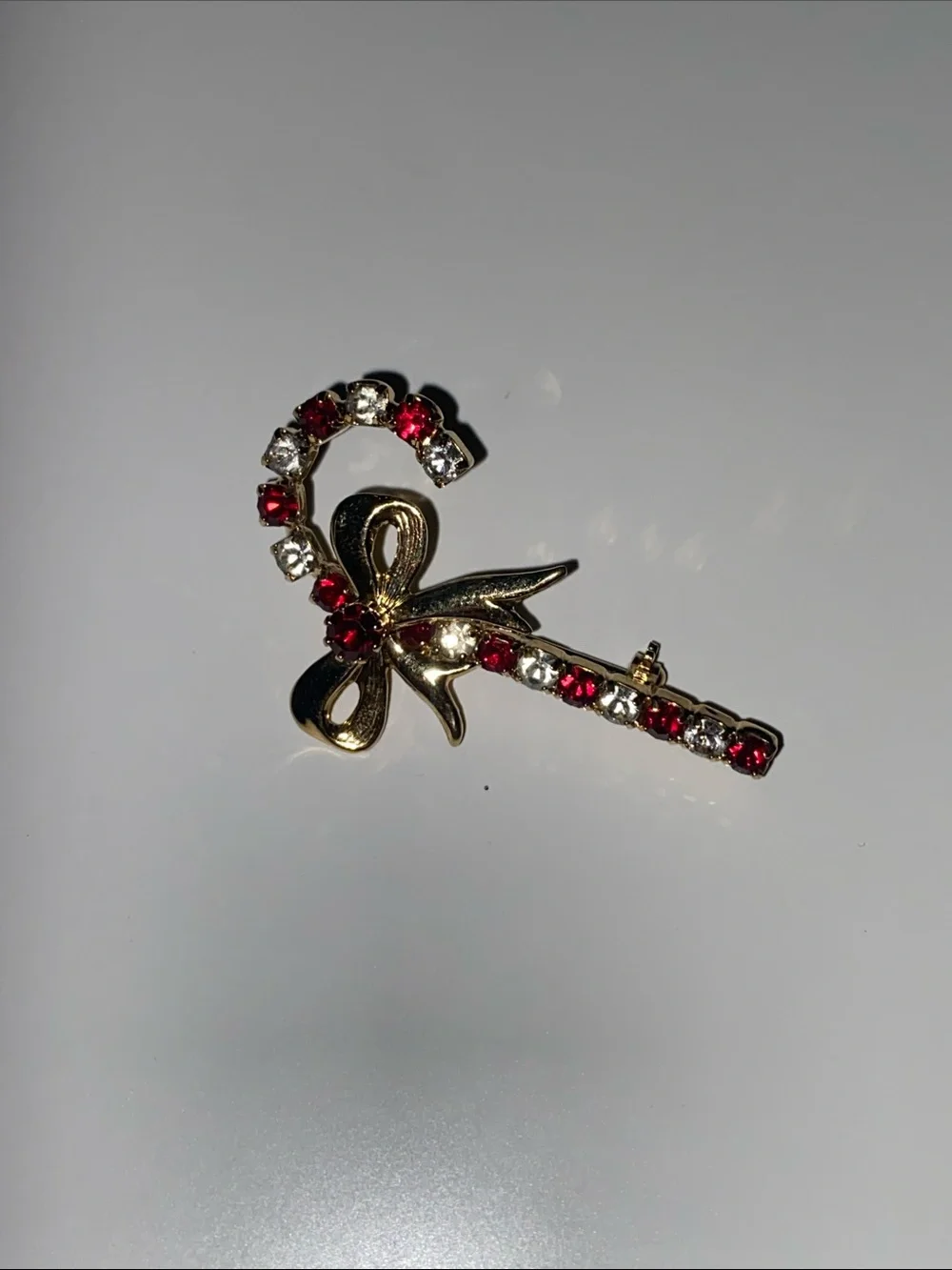 Gold Bow Candy Cane Brooch with Red and Clear Crystals